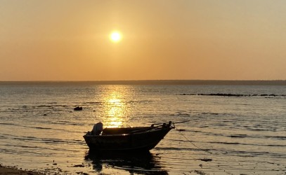 A boat on the ocean in Maningrida at sunset