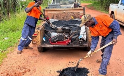 Council workers fixing pot holes on the airport road 