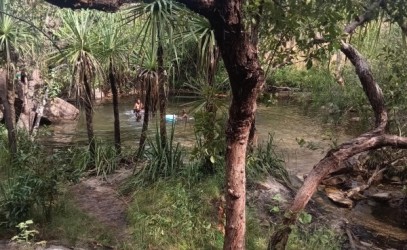 People enjoying swimming in a waterhold in Gunbalanya