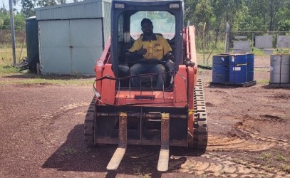 Man on a bob cat smiling 