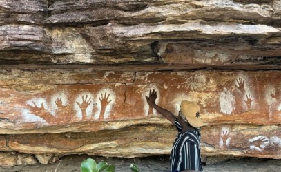 Man standing at a rock art painting 