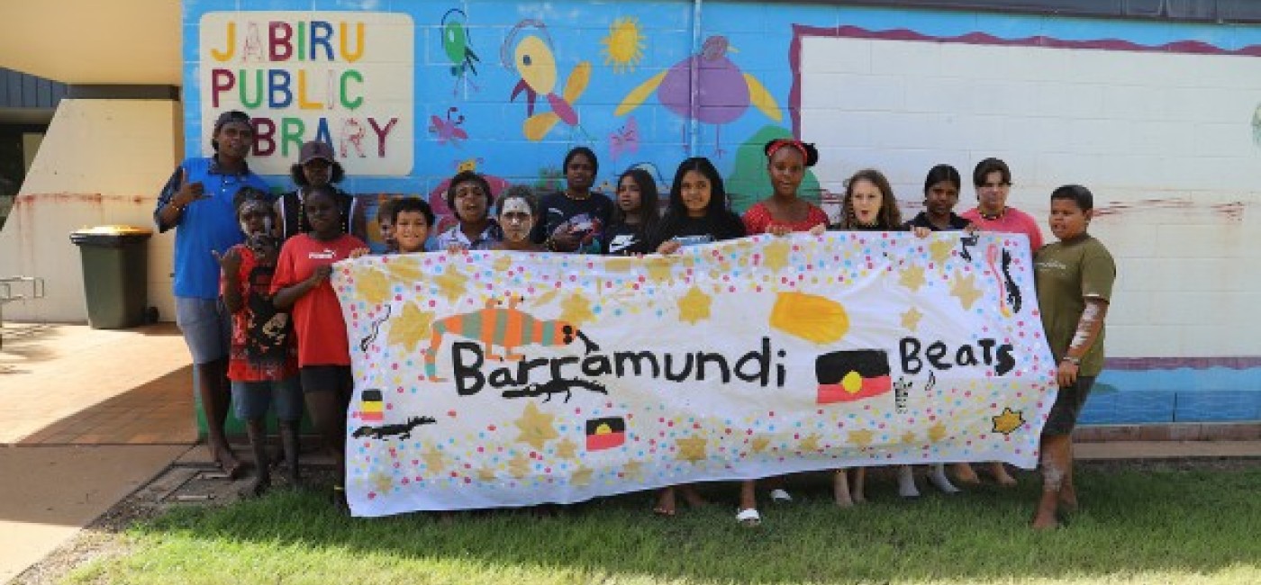 Young people in Jabiru holding up a banner that says Barramundi Beats