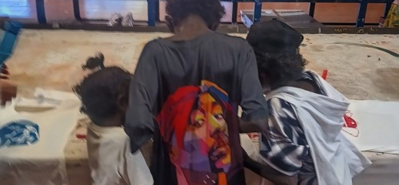 Three children working on creating screen prints
