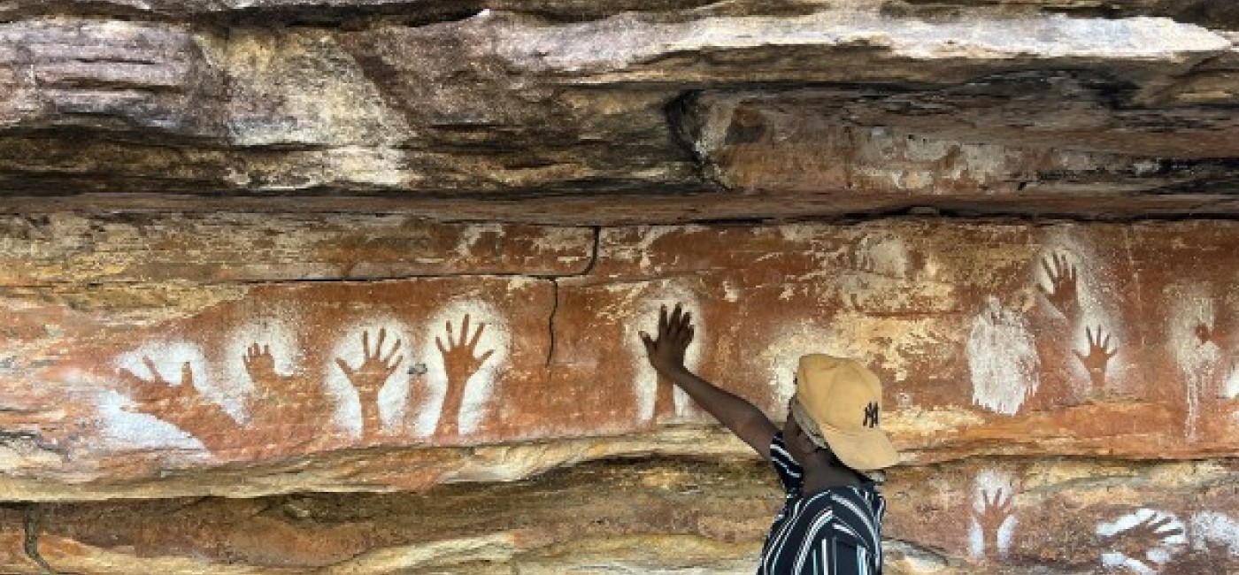 Man standing at a rock art painting